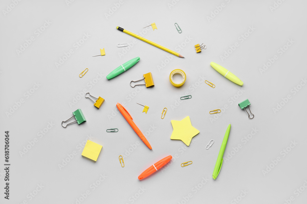 Composition with stationery supplies on grey background