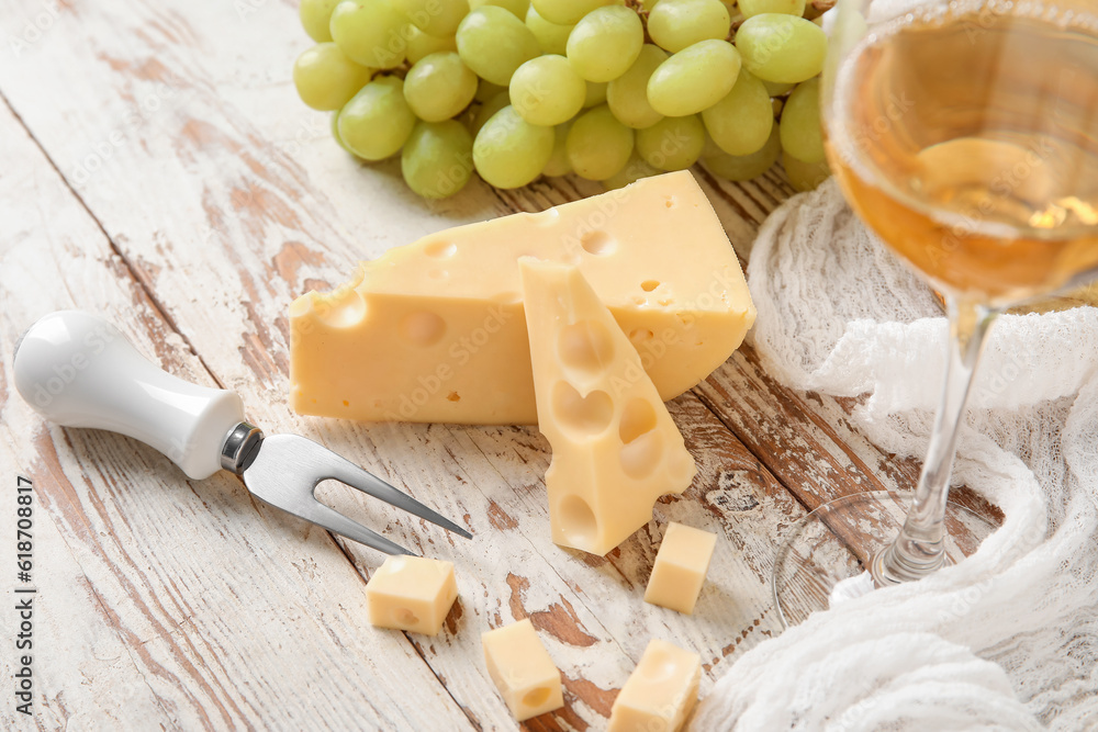 Tasty Swiss cheese on light wooden background