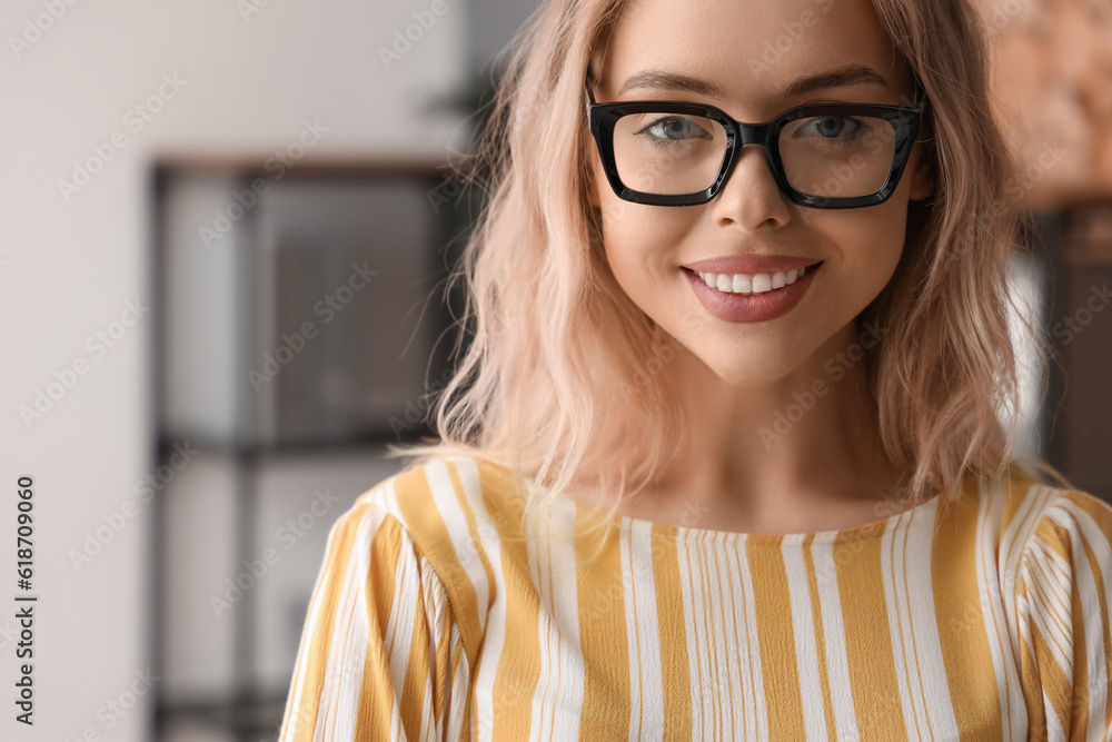 Young woman with stylish eyeglasses in office, closeup