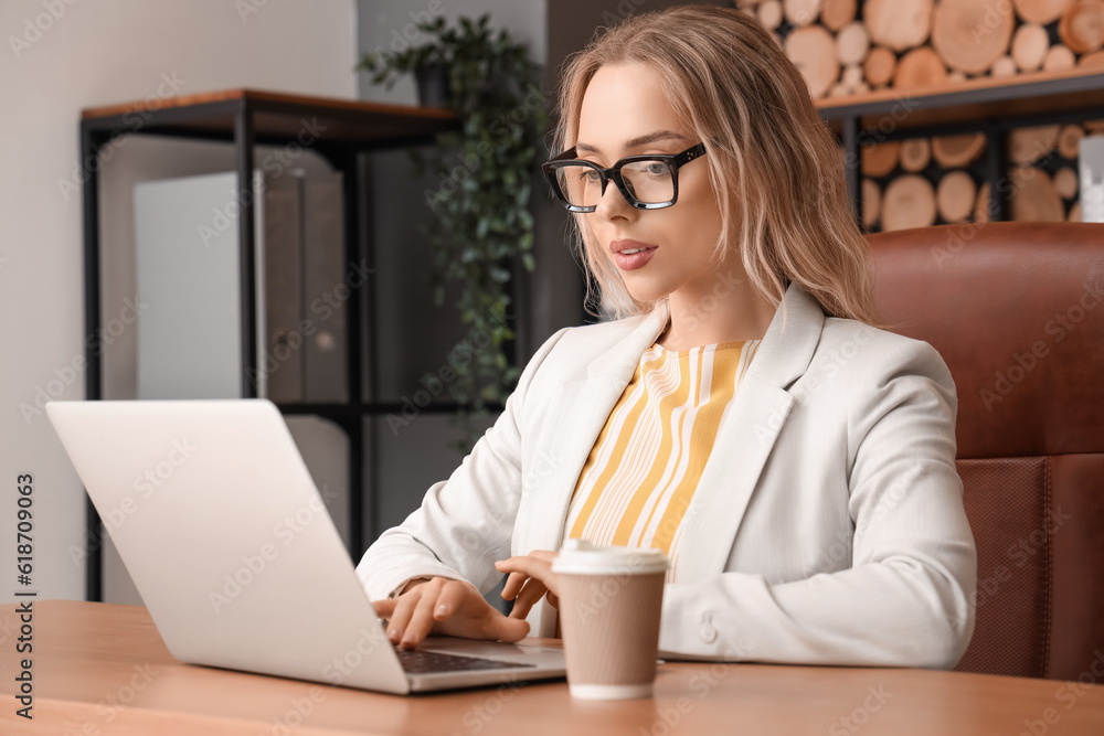 Young businesswoman working with laptop in office