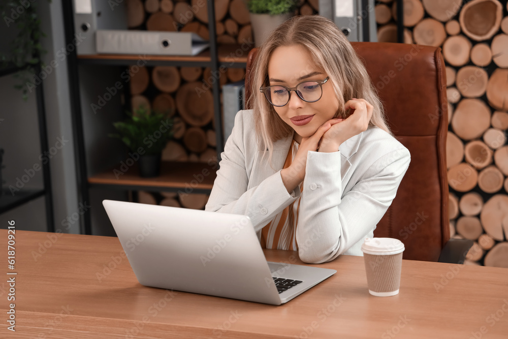 Young businesswoman working with laptop in office