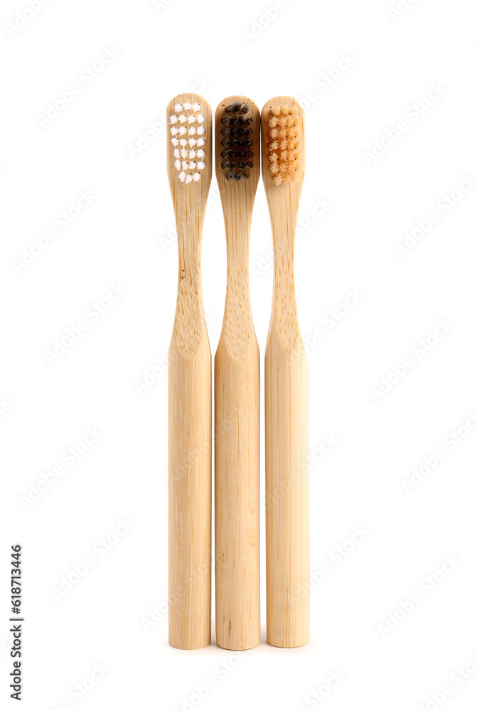 Bamboo tooth brushes on white background