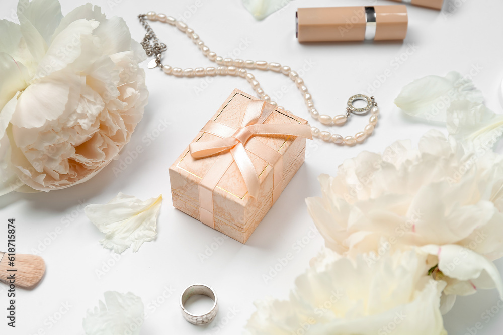 Composition with gift box, female accessories, cosmetics and peony flowers on white background