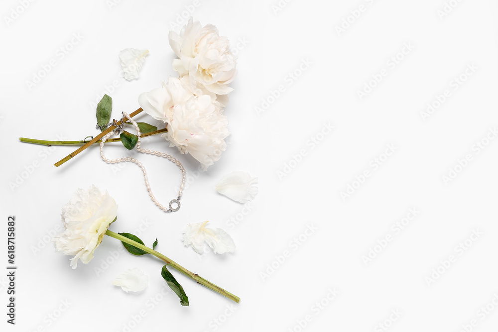 Composition with stylish female necklace and beautiful peony flowers on white background