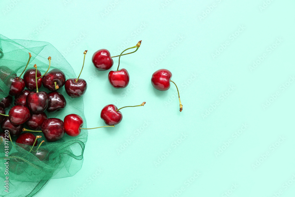 Eco bag with sweet cherries on turquoise background