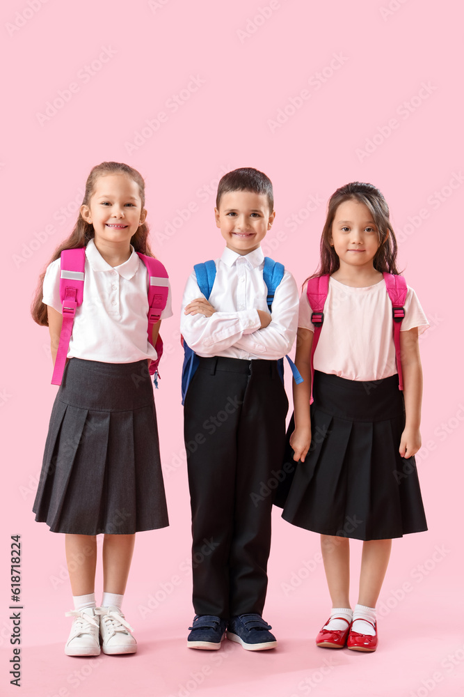 Little schoolchildren on pink background