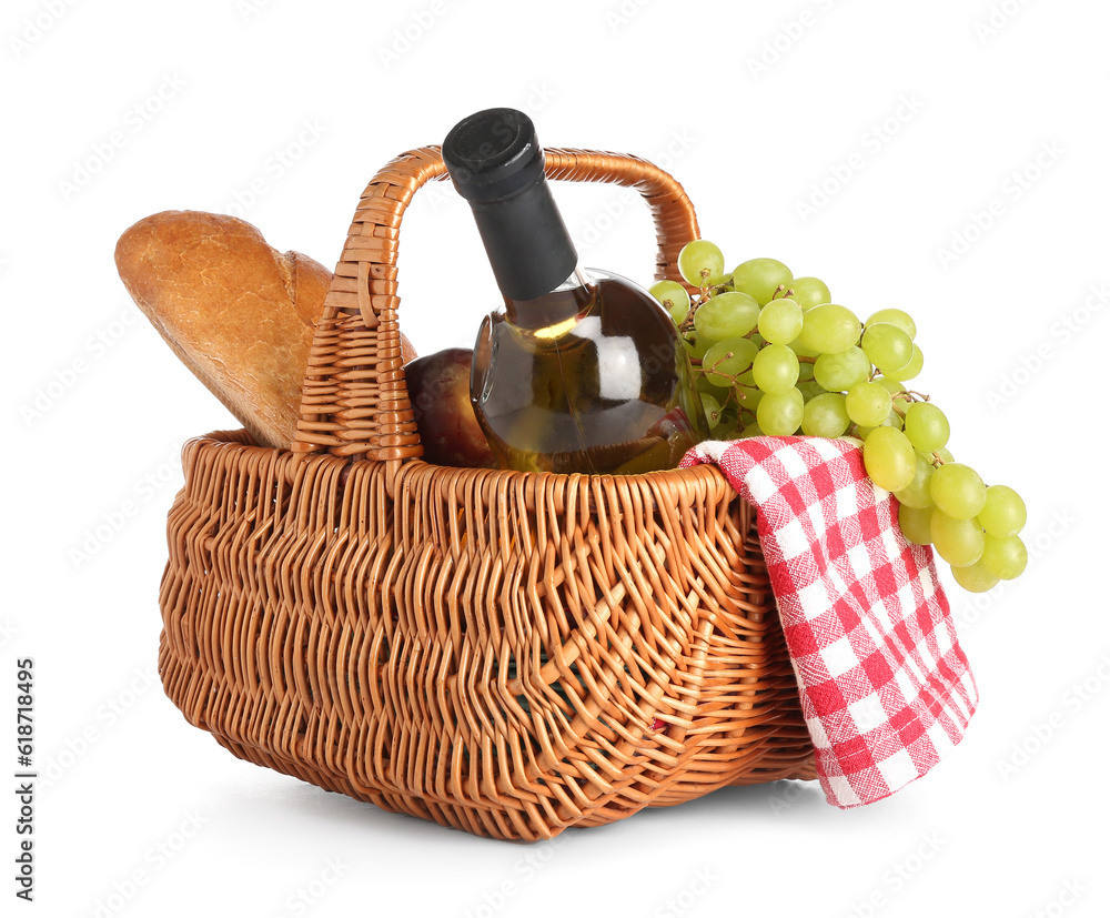 Wicker basket with tasty food for picnic and wine on white background