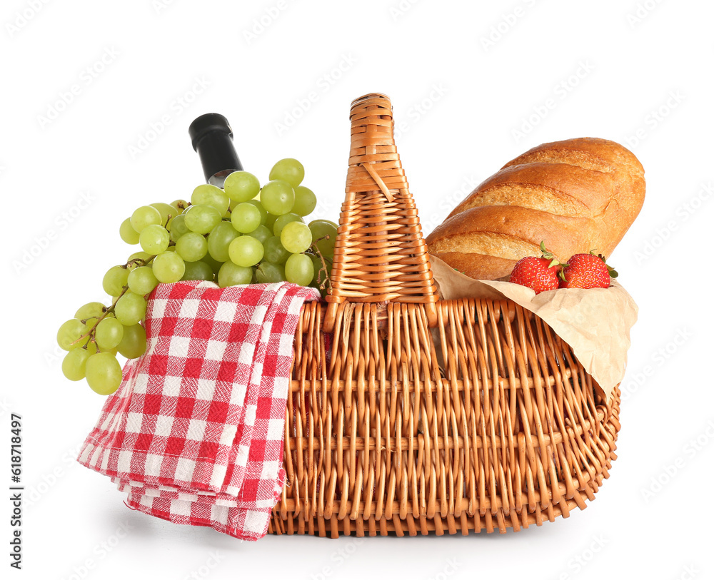 Wicker basket with delicious food for picnic on white background