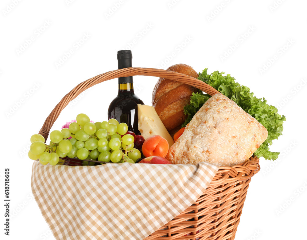 Wicker basket with tasty food for picnic and wine on white background