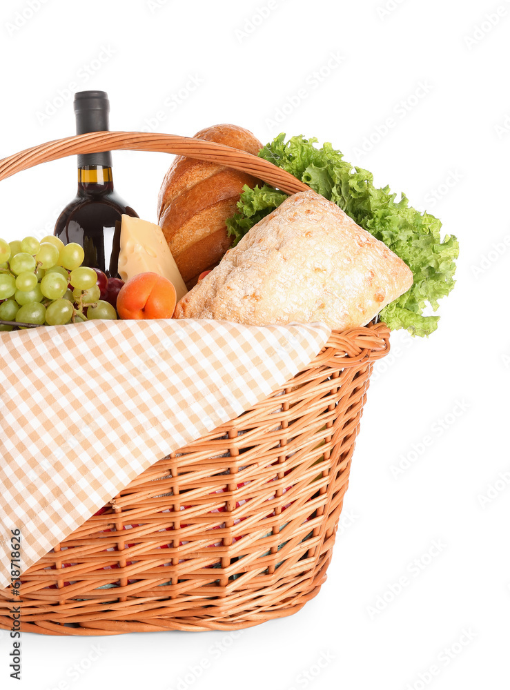 Wicker basket with tasty food for picnic and wine on white background