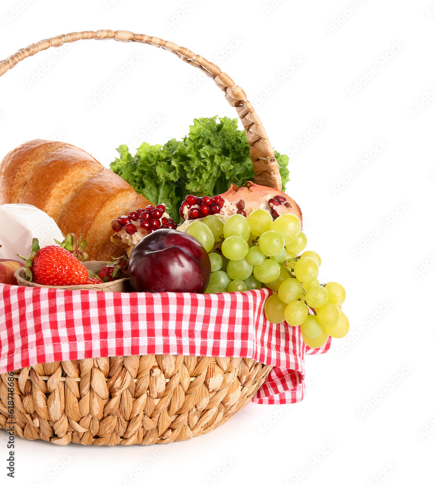 Wicker basket with delicious food for picnic on white background