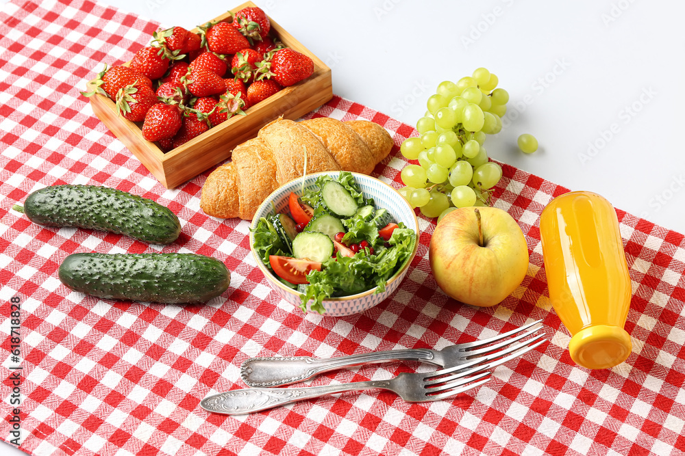 Bowl with salad, tasty food and juice for picnic on white background