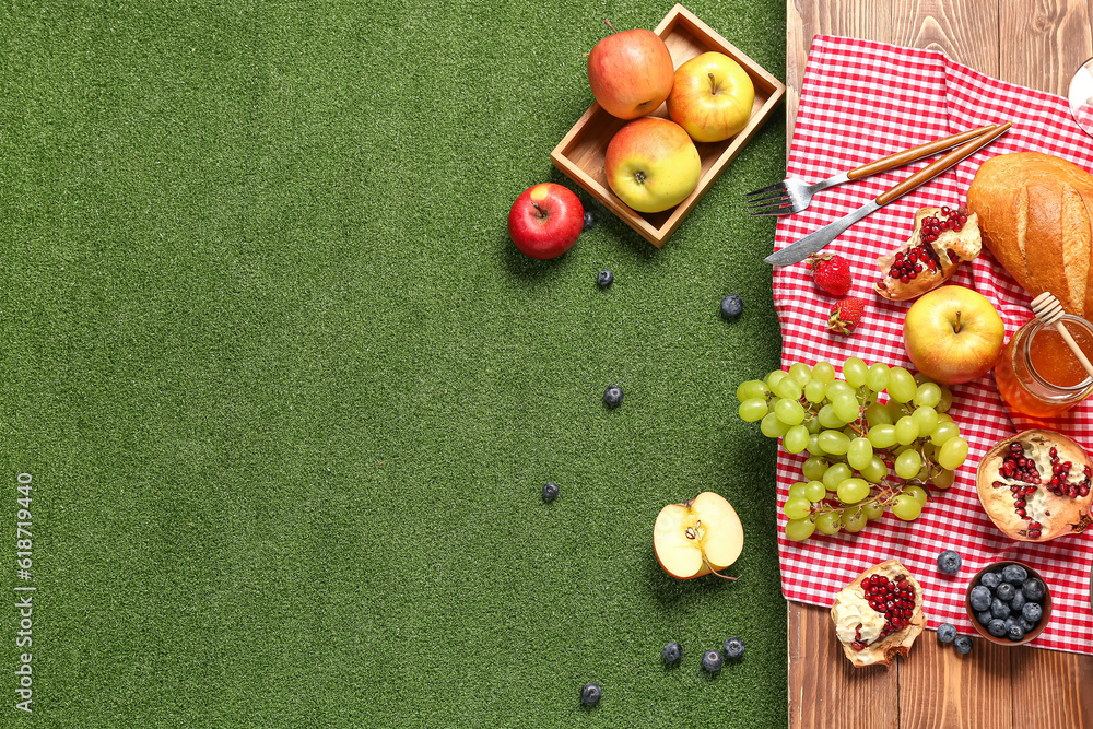 Composition with tasty food for picnic on wooden table outside