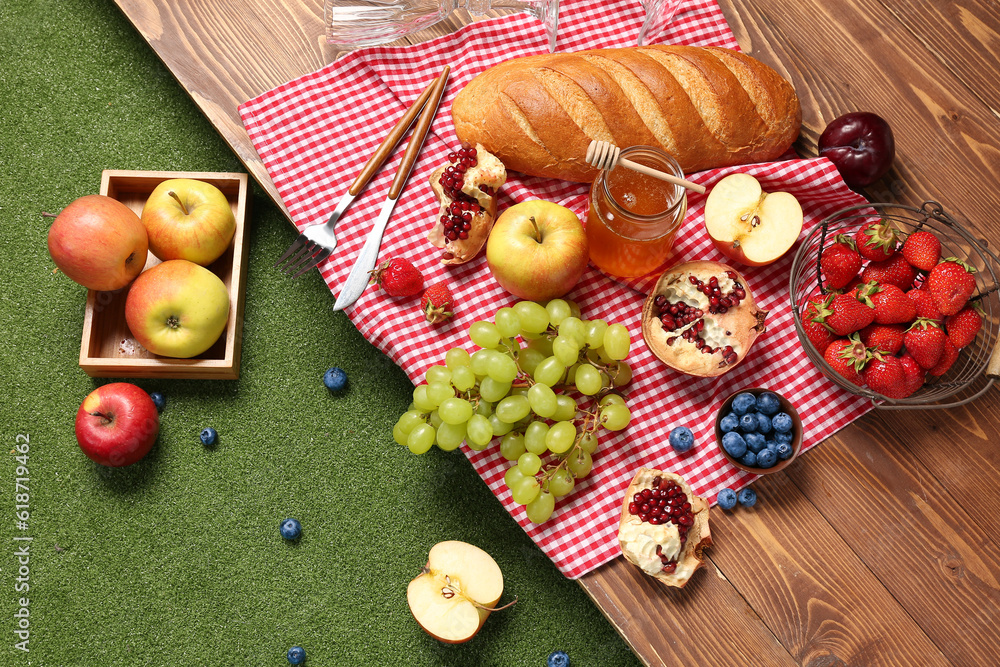 Composition with tasty food for picnic on wooden table outside