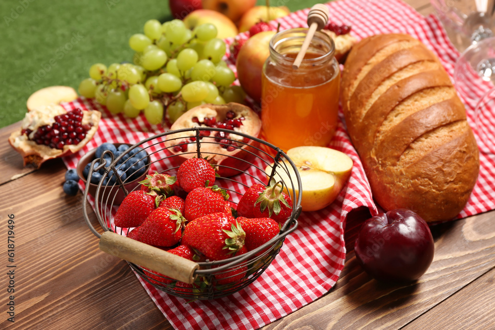 Composition with tasty food for picnic on wooden table outside, closeup