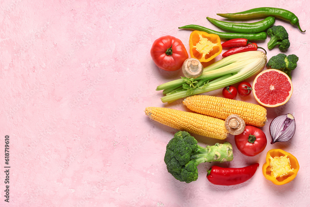 Fresh ripe vegetables on pink background