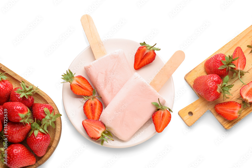 Plate with sweet strawberry ice-cream popsicles and board of berries on white background