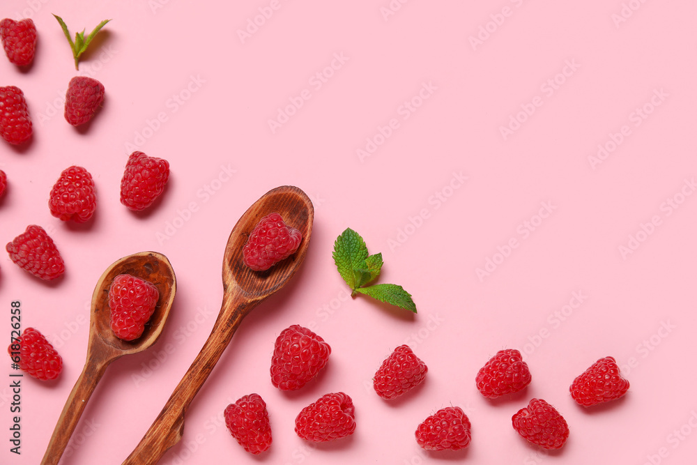 Spoons with fresh raspberries and mint on pink background