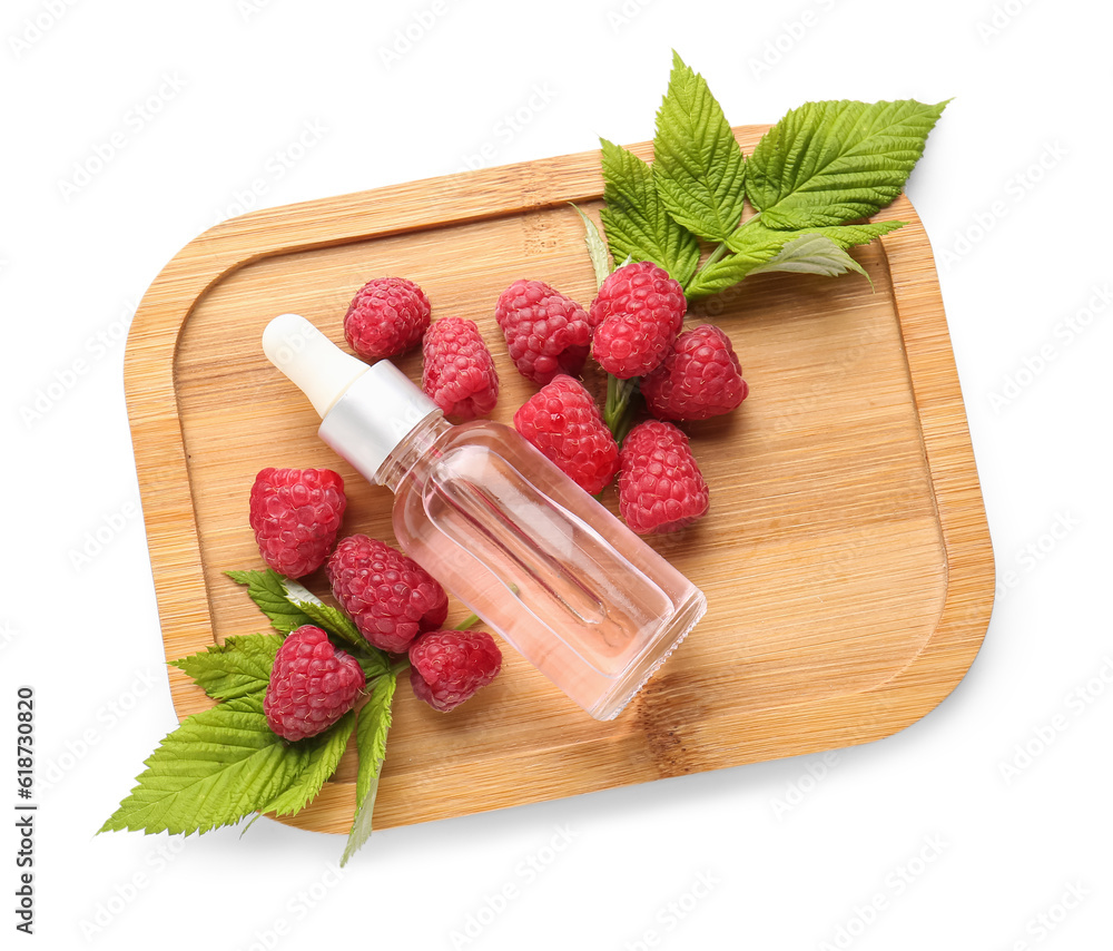 Wooden board with bottle of cosmetic raspberry oil on white background