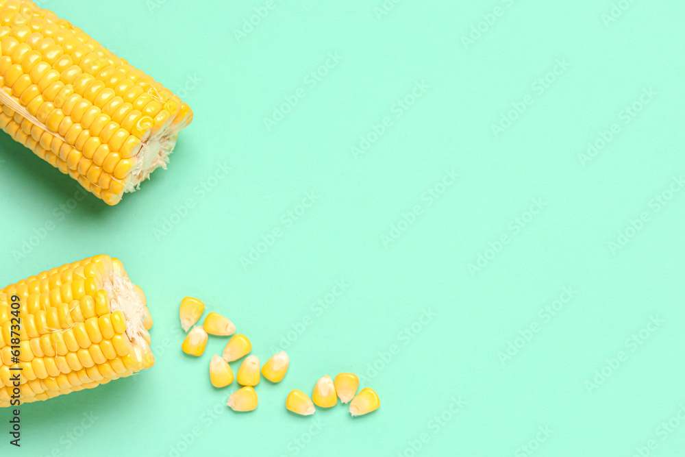 Cut fresh corn cobs and seeds on turquoise background