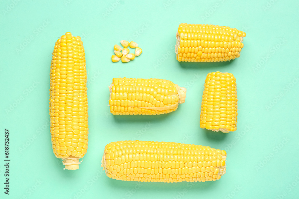 Fresh corn cobs and seeds on turquoise background