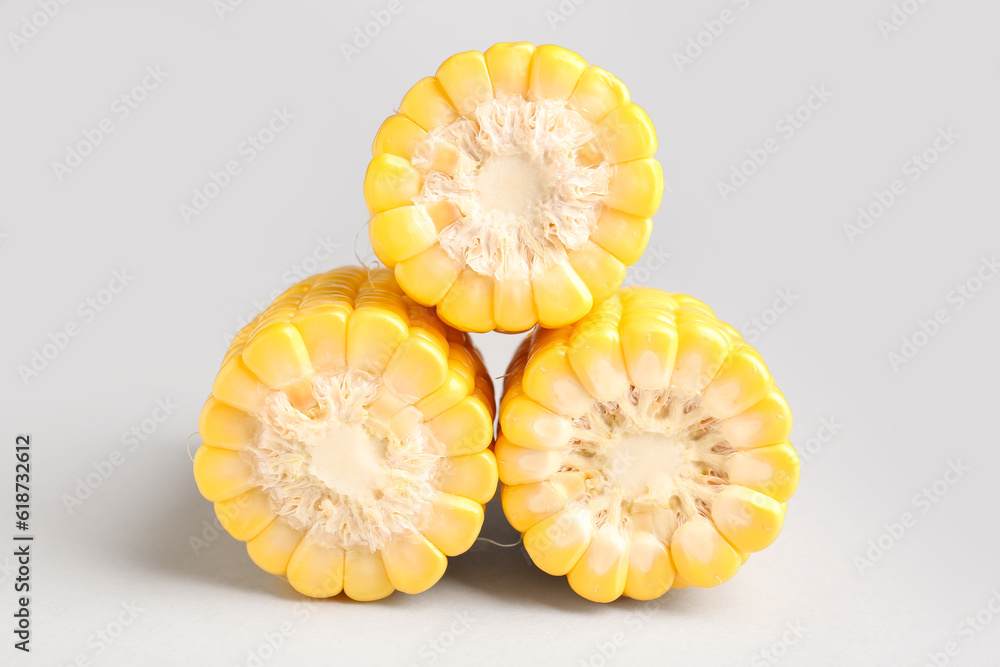 Cut fresh corn cobs on grey background