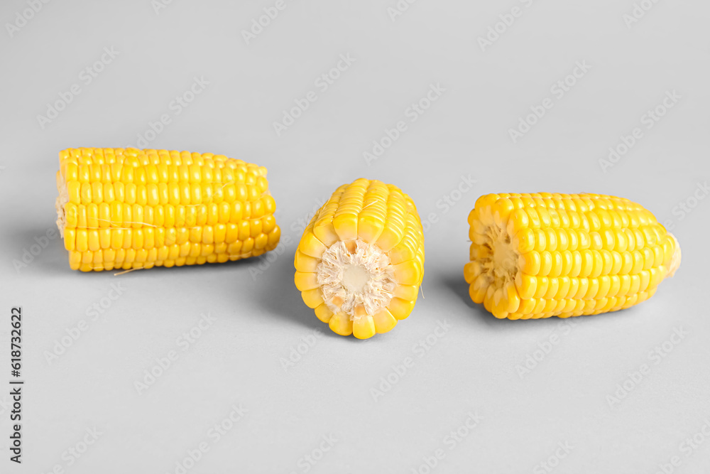 Cut fresh corn cobs on grey background