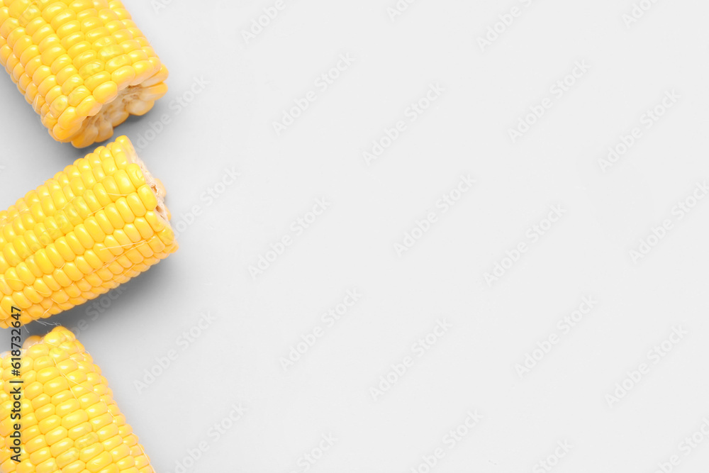 Cut fresh corn cobs on grey background