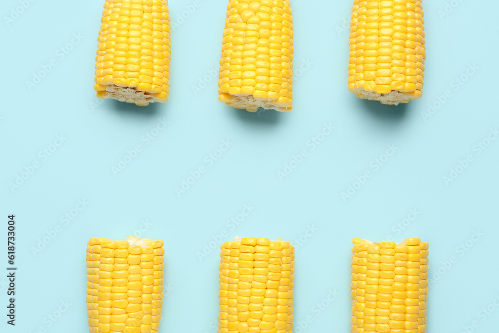 Cut fresh corn cobs on blue background