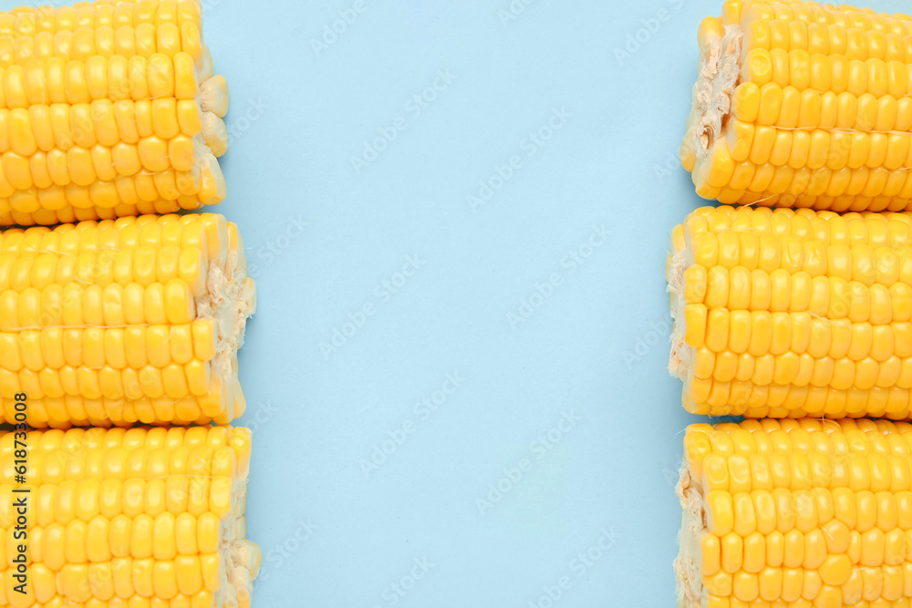 Cut fresh corn cobs on blue background