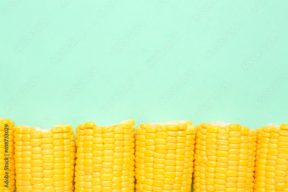 Cut fresh corn cobs on blue background