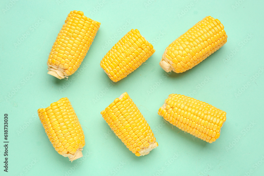 Cut fresh corn cobs on blue background