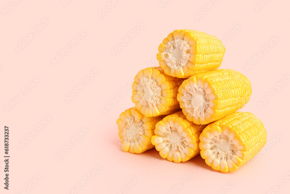 Cut fresh corn cobs on pink background