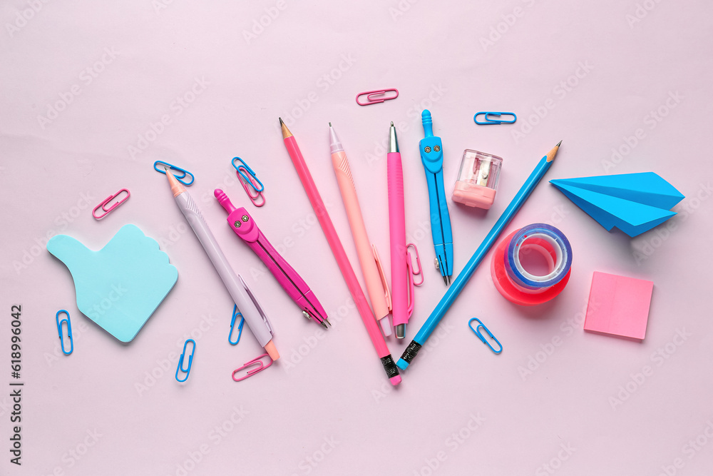 Composition with stationery supplies on pink background