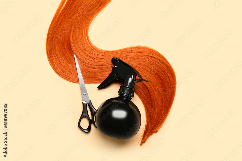 Ginger hair strand, scissors and sprayer on color background