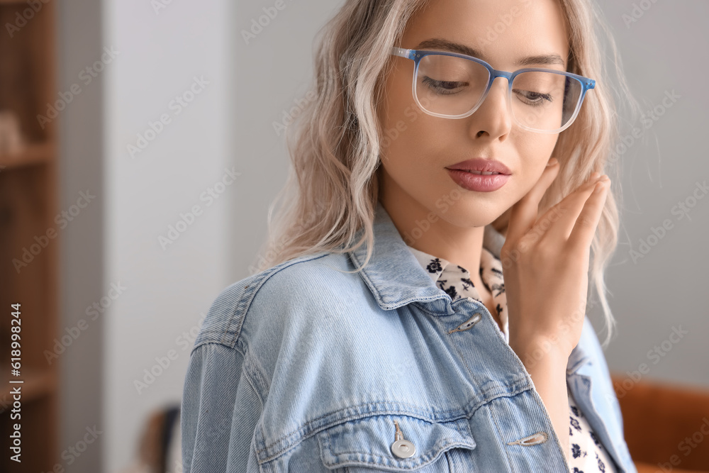 Young woman in stylish eyeglasses at home, closeup