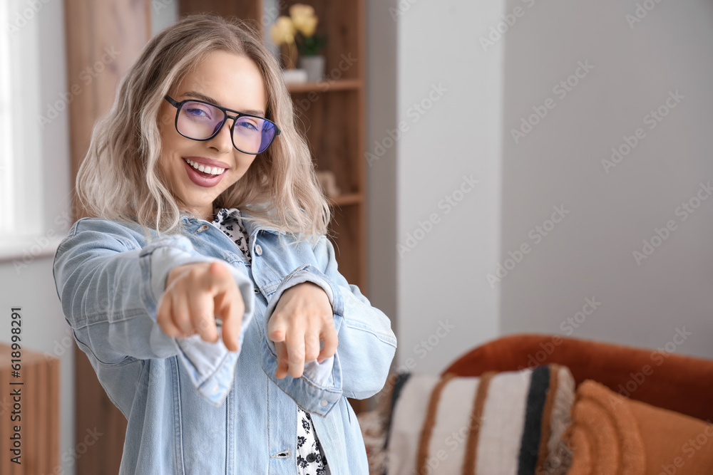 Happy young woman in stylish eyeglasses at home