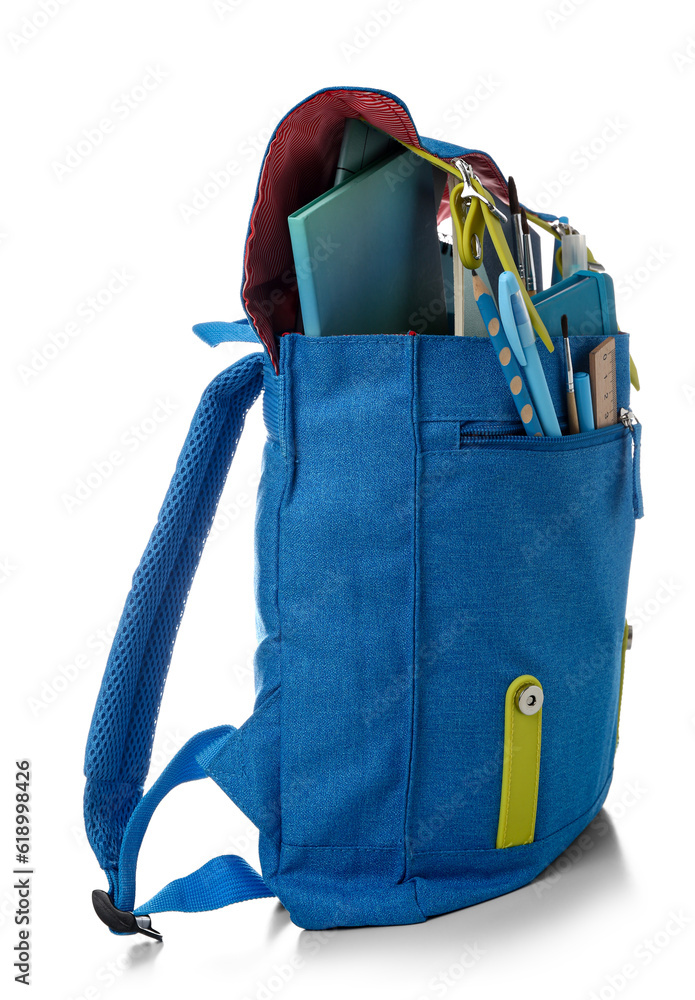 Blue school backpack with notebooks, brushes and markers on white background