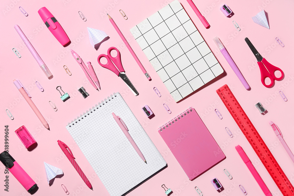 Set of different school stationery on pink background