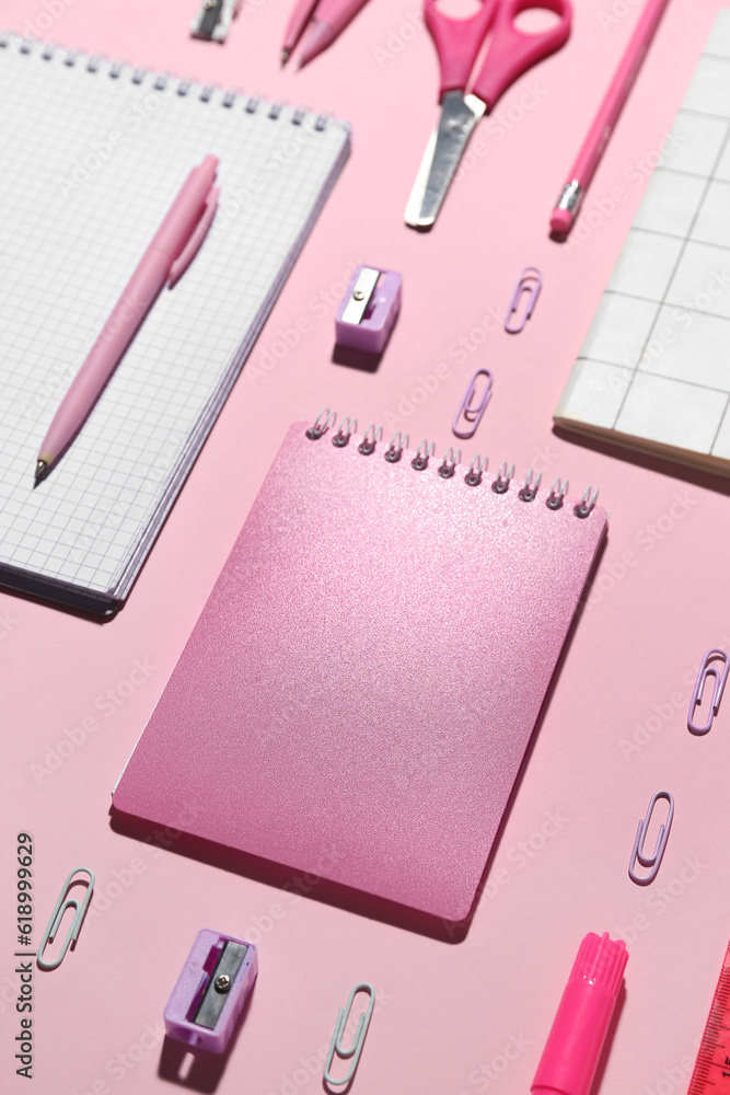 Set of different school stationery on pink background