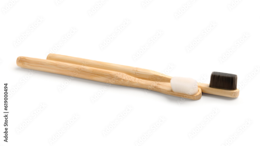 Bamboo tooth brushes on white background