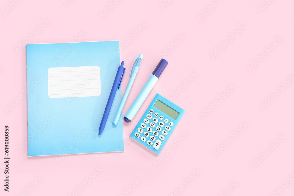 Notebook with different stationery on pink background