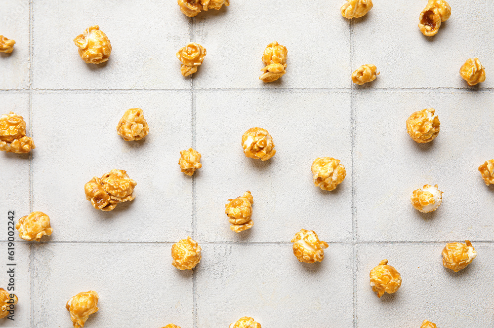 Tasty popcorn on white tile background