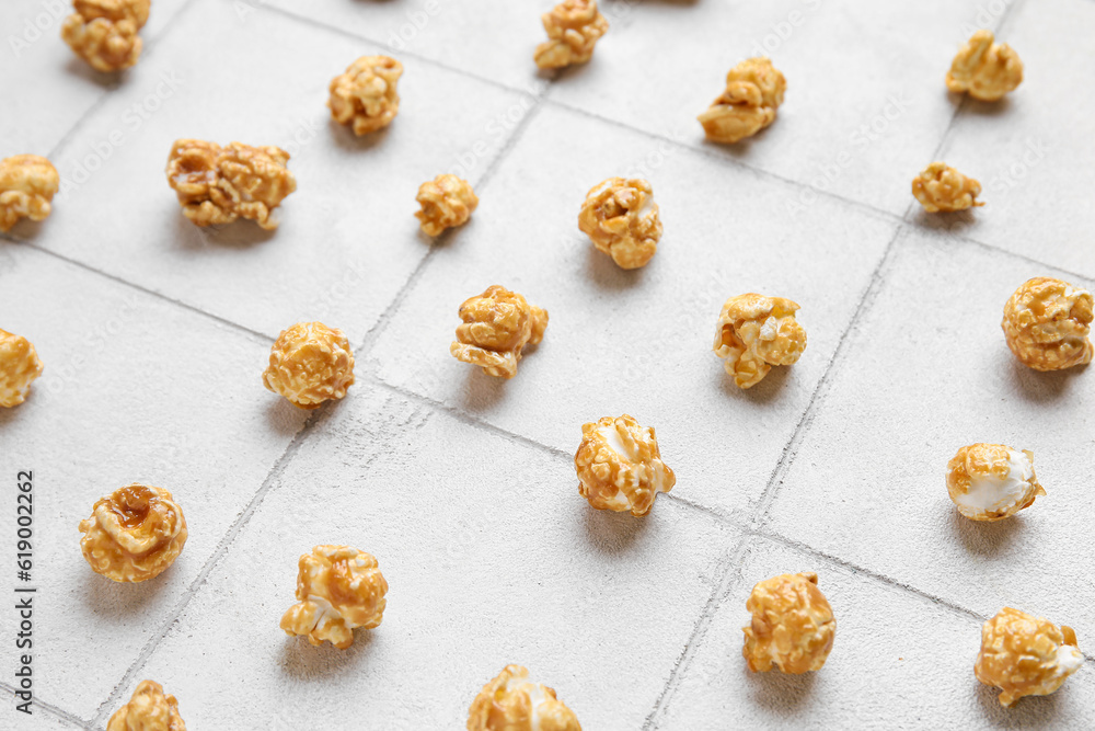 Tasty popcorn on white tile background