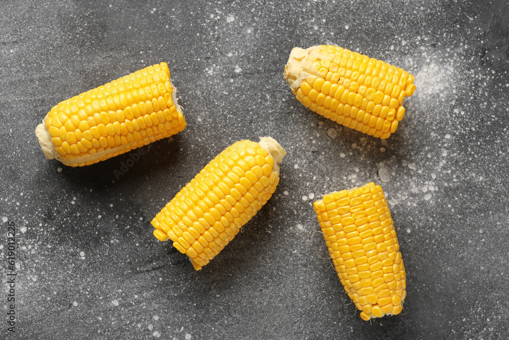 Cut fresh corn cobs on grey background