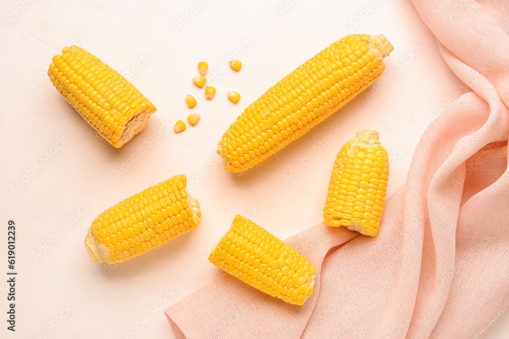 Fresh corn cobs and seeds on white background