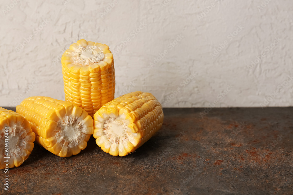 Cut fresh corn cobs on dark table