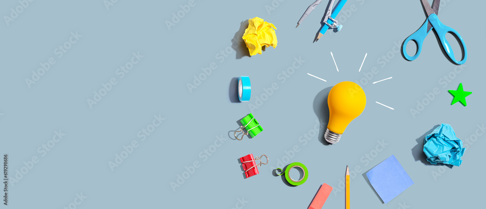 Idea light bulb with school supplies overhead view - flat lay