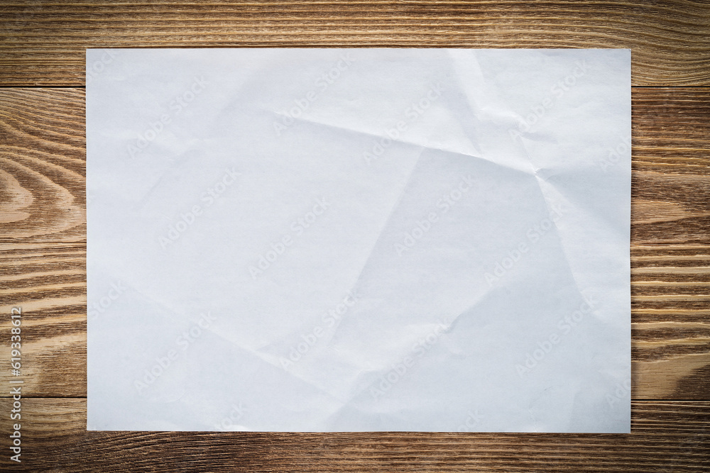 Sheet of paper lying on wooden table