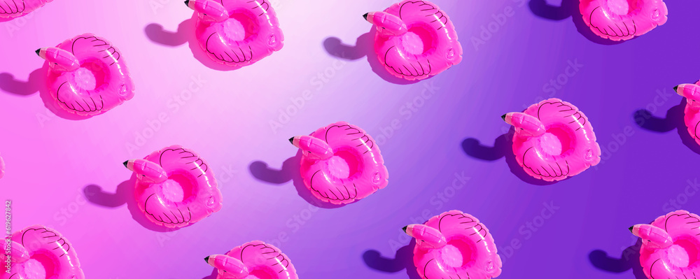 Summer concept with pink flamingo floats - flat lay